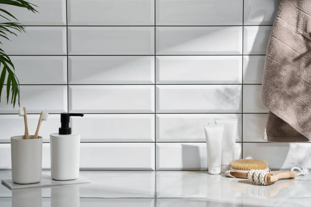 istock Marble shelf in the bathroom with various objects against a background of white tiles 2149280333