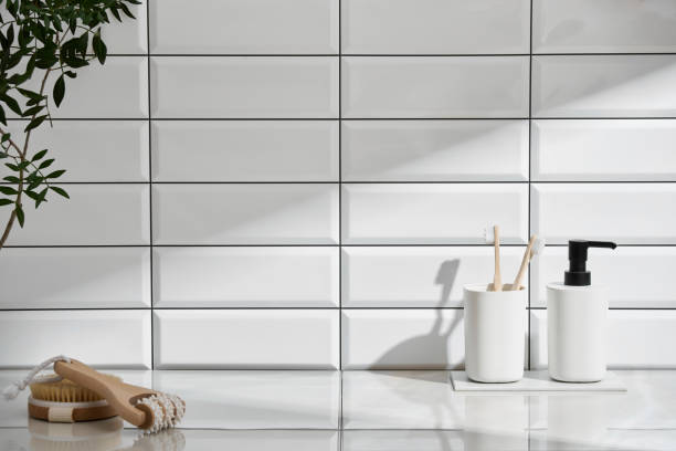 istock Marble shelf in the bathroom with various objects against a background of white tiles 2149280340
