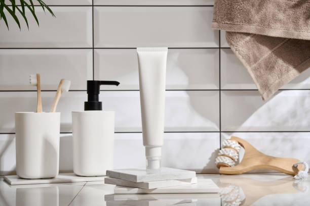 istock Bathroom concept with towel, toothbrushes, white tile wall background. 2149280381