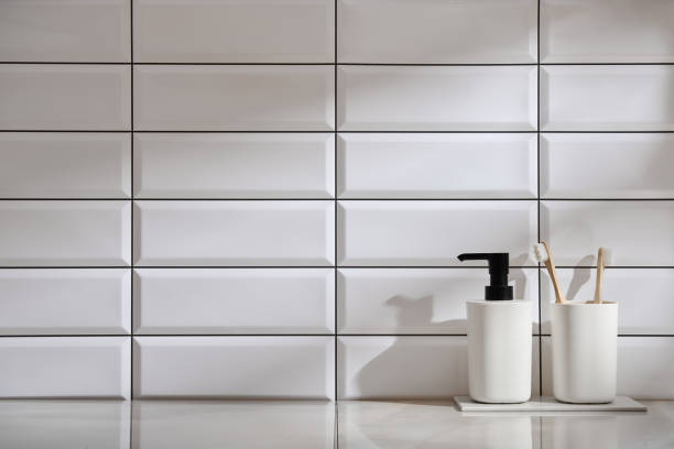 istock Marble shelf in the bathroom with various objects against a background of white tiles 2149280483