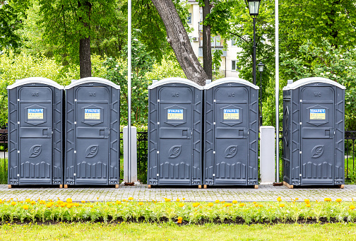 Samara, Russia - May 20, 2022: Portable plastic public toilets at the city street in summer