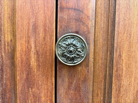 Vintage metal door knob on a wooden background isolated close-up in San Cristobal de La Laguna, Tenerife, Canary Islands, Spain, no people