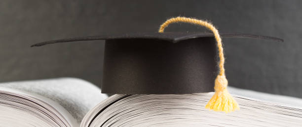istock Open book on wooden deck table and black board background. Back to School. Education concept with copy space for your ad text. 2149284690