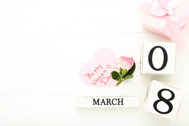 istock Wooden calendar with gift box and text Happy Women's Day on white background 2149284992
