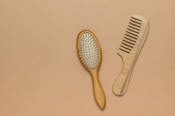 istock Two classic wooden combs on a light beige background. 2149285037