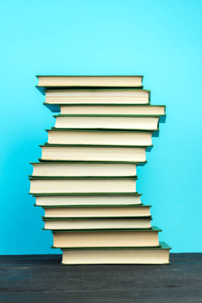 istock Books on wooden table, on a blue background. Back to school. Copy space for text. Education background. 2149285293