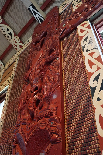 New Zealand maori carvings on wall in a traditional meeting house