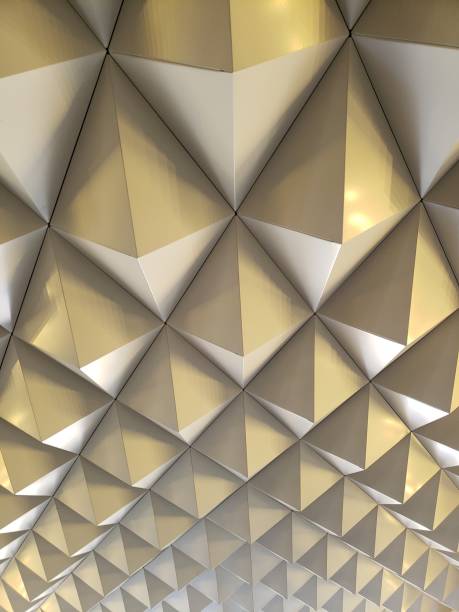 istock A captivating sculptural installation with metal pyramids on a wall plays with light and shadow to create dynamic color shifts and depths, offering mesmerizing visual effects. 2149285300