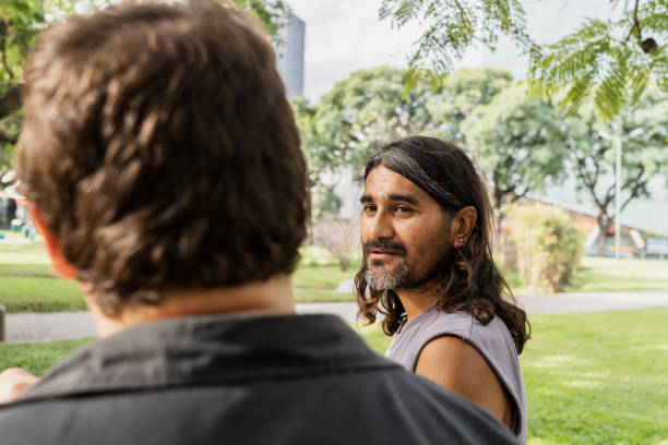 istock Mature man talking and walking with friend around the park 2149288369