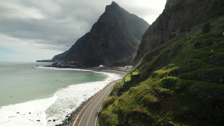 Aerial of Scenic Road, Coastline, Waves, Steep Mountains, Driving Cars; Madeira Footage 4k