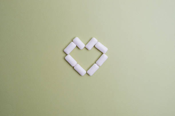 Tasty white chewing gums on color background, flat lay
