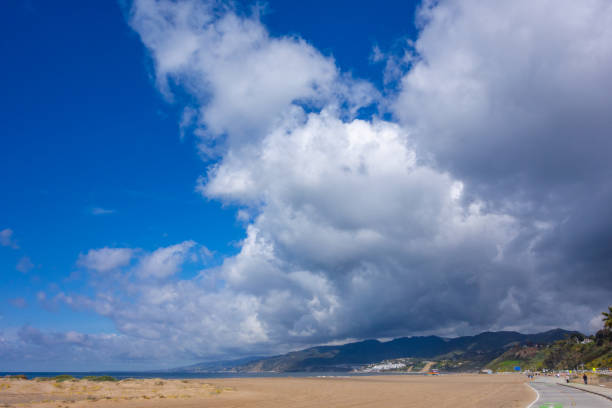 Biking North towards Will Rogers State Beach on the Marvin Braude Bike Path in Los Angeles on a cloudy day.