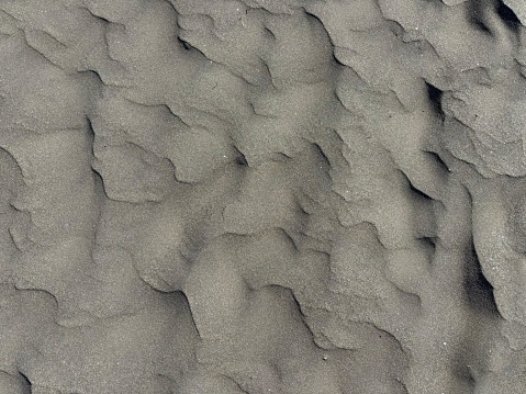 Gray volcanic sand texture after rainy and windy weather, El Medano, Tenerife, Canary Islands, Spain, no people