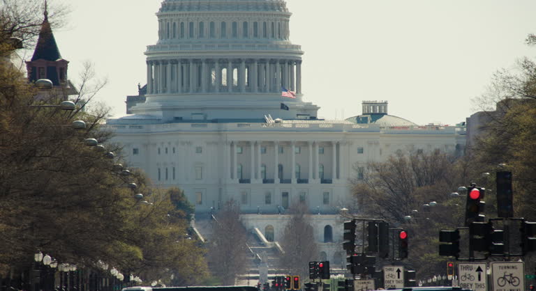 Telephoto Shot of U.S. Capitol with Flag Waving in Breeze