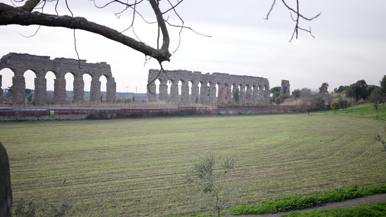Train travels through park, along ancient Roman aqueducts