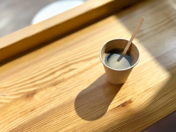 istock black takeaway coffee in a brown paper cup on a cafe table 2149295879