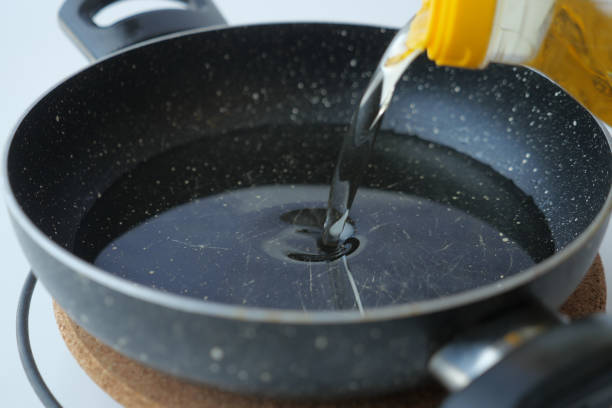 istock pouring sunflower oil in a cooking pan 2149296740