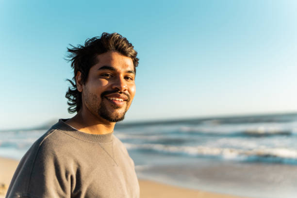 istock Portrait of a young man on the beach 2149296956