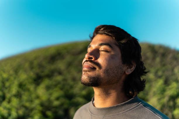 istock Young man contemplating with eyes closed outdoors 2149296959