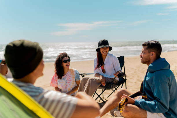 istock Friends talking and singing on the beach 2149297373
