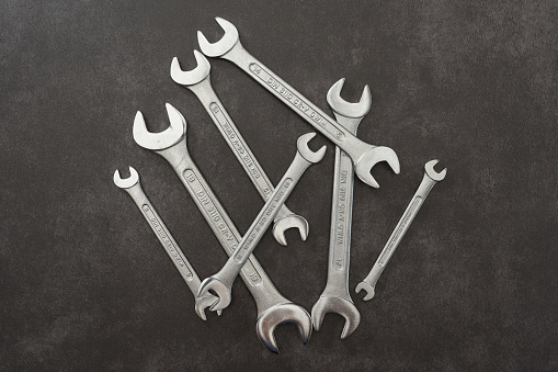 Selecting wrench from instruments set of repair shop