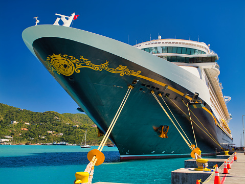 Tortola, BVI - Jan 23 2024: The Disney Fantasy cruise liner moored at the Cyril B. Romney Tortola Pier in Road Town, Tortola, BVI. Taken on a hot, sunny day.
