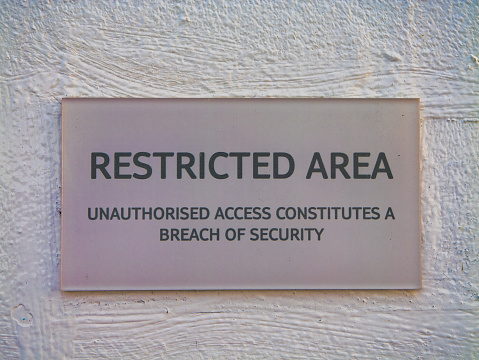 At Sea - Jan 28 2024: A sign advising that an area is restricted and that unauthorised access constitutes a breach of security.