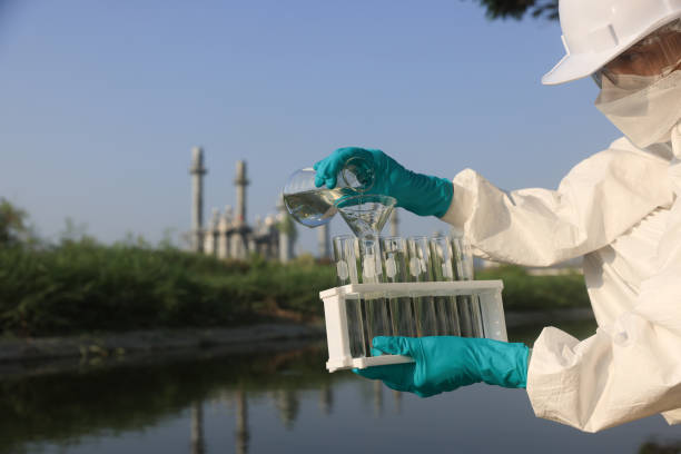 istock environmentalist use a chemical flask to collect the  samples of toxic water for testing and check with quality of water from industrial 2149301588