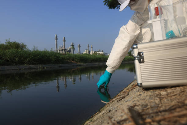 istock Female Scientists wearing white Chemical protective and PPE with water analysis mobile laboratory equipment check toxic wastewater from industrial 2149301755