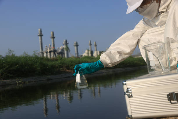 istock Female Scientists wearing white Chemical protective and PPE with water analysis mobile laboratory equipment check toxic wastewater from industrial 2149301777