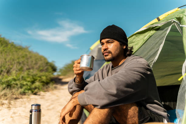 istock Young man contemplating and looking at view on the beach 2149302643