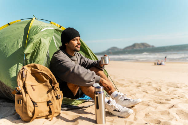 istock Young man contemplating and looking at view on the beach 2149302657