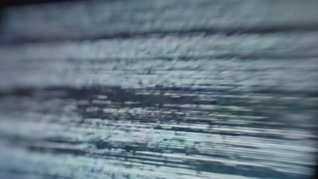 Extreme close up of a digitial computer device screen displaying a choppy static noise signal.
