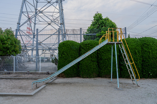鉄塔のある背景と公園の滑り台