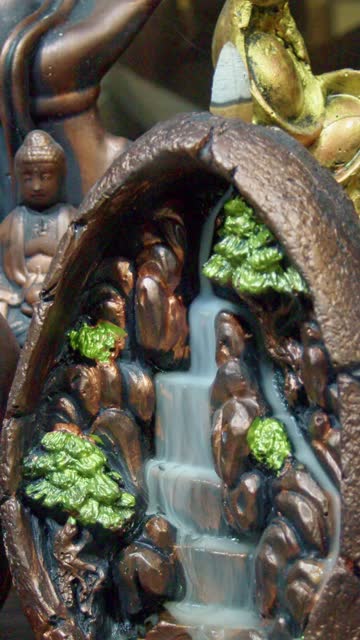 Incense smoke waterfall with green tree figures