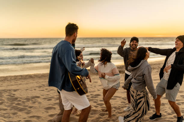 istock Friends dancing and having fun on the beach 2149306928