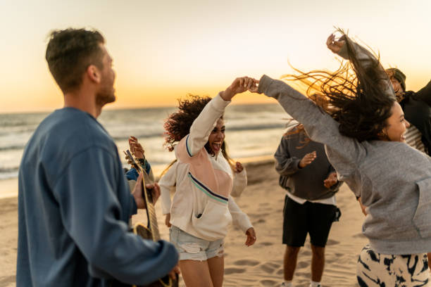 istock Friends dancing and having fun on the beach 2149306939
