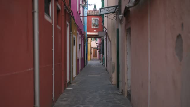 Handheld Shot of Colorful Alleyway Between Historic Buildings, Burano Island, Venice Daytime