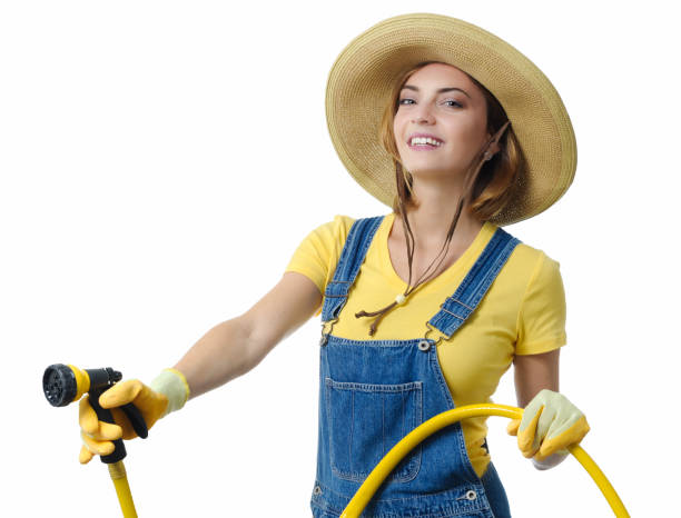 istock Young woman watering garden 2149308940