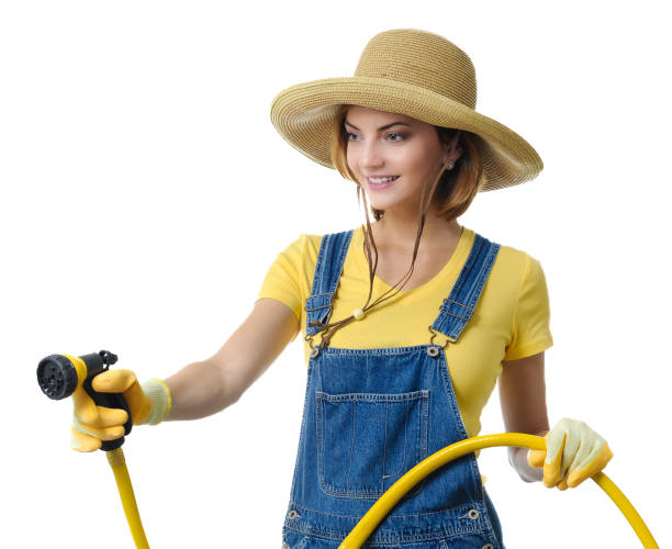 istock Young woman watering garden 2149308942