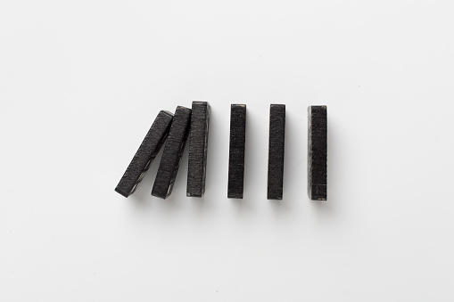 Black domino tiles on white background, top view