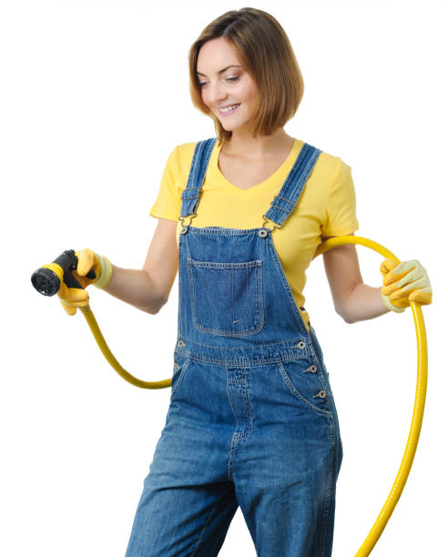 istock Young woman watering garden 2149313255