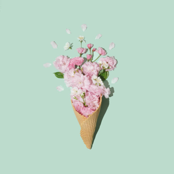 istock Ice cream cone with Japanese cherry blossoms on pastel mint background. Minimal summer flat lay composition. 2149314639