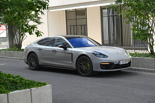 Berlin, Germany - 6th June, 2021: Porsche Panamera 4S e-hybrid parked on a street. This model is one of the most popular large premium vehicles in Europe.
