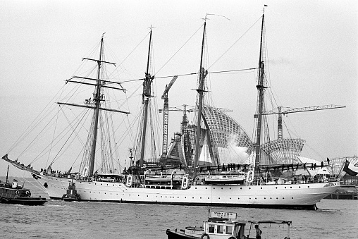 The sailing ship Esmerelda passing the construction of the Sydney Opera House in 1966.