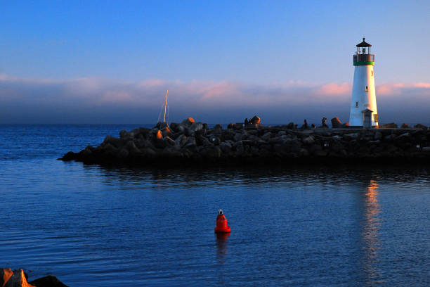 Blyth lighthouse and pier in Northumberland against cloudscape