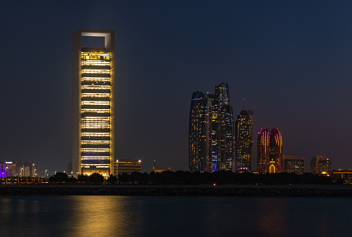 Abu Dhabi, United Arab Emirates - November 9, 2023: A picture of the Etihad Towers and the Abu Dhabi National Oil Company Headquarters at night.