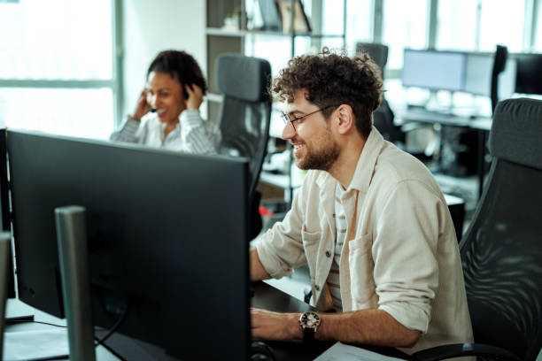 istock Young handsome man working on desktop PC at the office 2149321215
