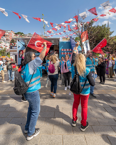 Istanbul, Turkey - May 13 2023: Supporters of Kemal Kilicdaroglu dancing while holding the Turkish flags in front of Republican Peoples Party kiosk in Uskudar neighbourhood during 2023 elections