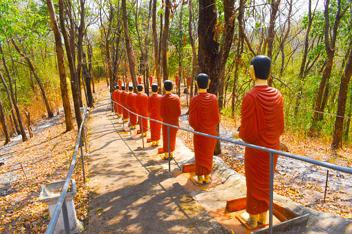 wat phra that doi ku kaew mekwanaram, way down the mountain, Pa Maet, Mueang Phrae District, Thailand, long row of monk statues, forest, artwork, crafts, attraction, point of interest